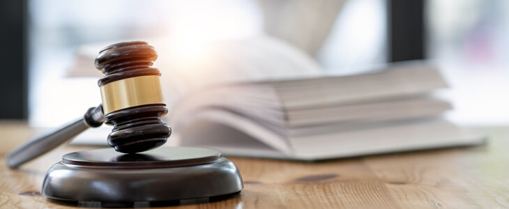 Wooden brown judge gavel on the table, copy space, banner background.