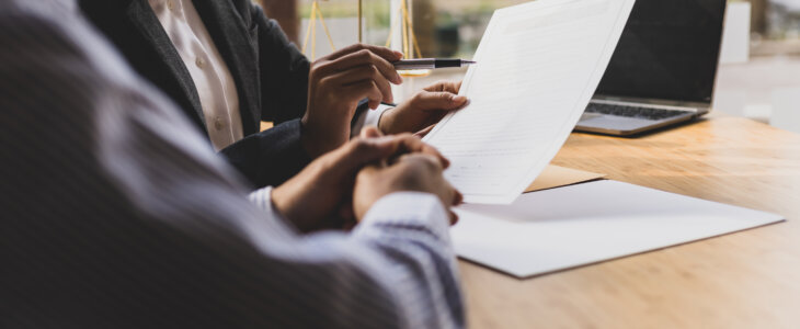 An attorney speaks to her client