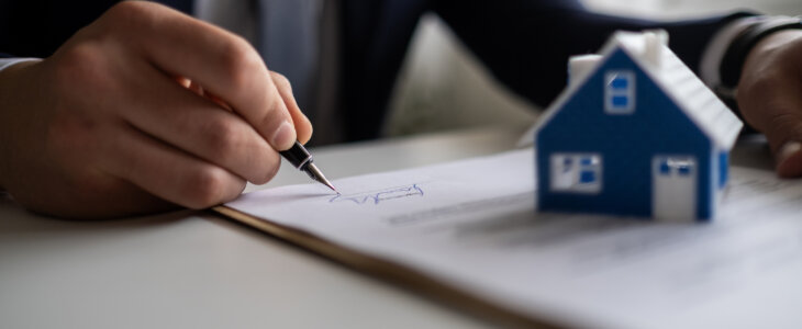 Businessman signing a legal real estate contract agreement, home Insurance.